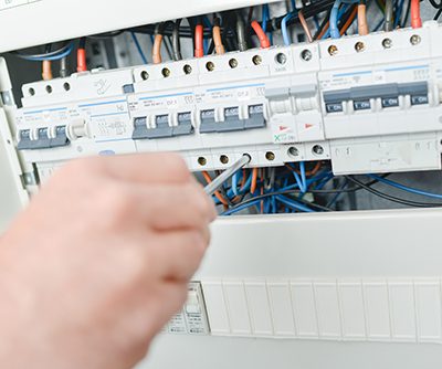 Electrician repairing a fuse